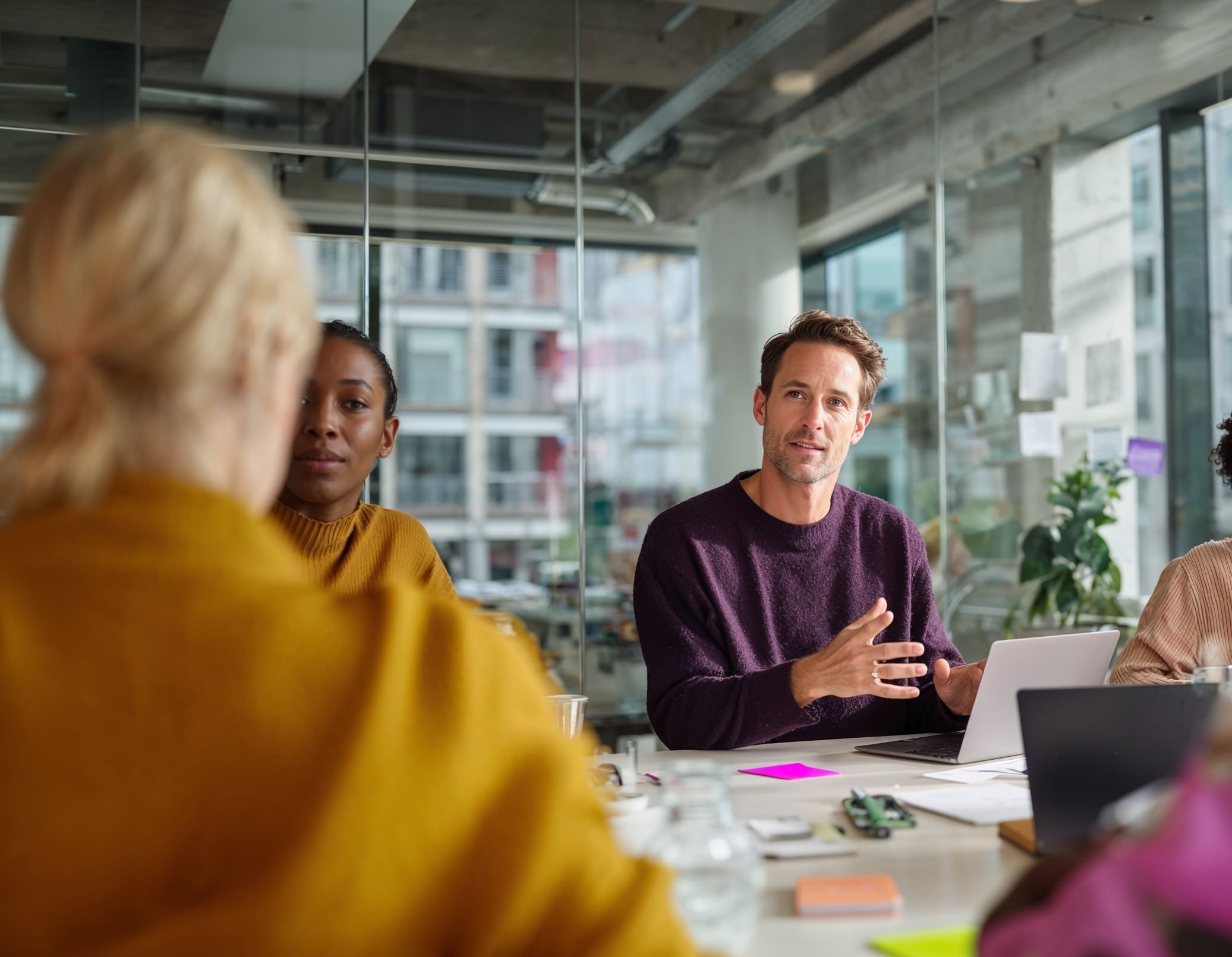 Diverse team collaborating around a conference table in a bright modern office