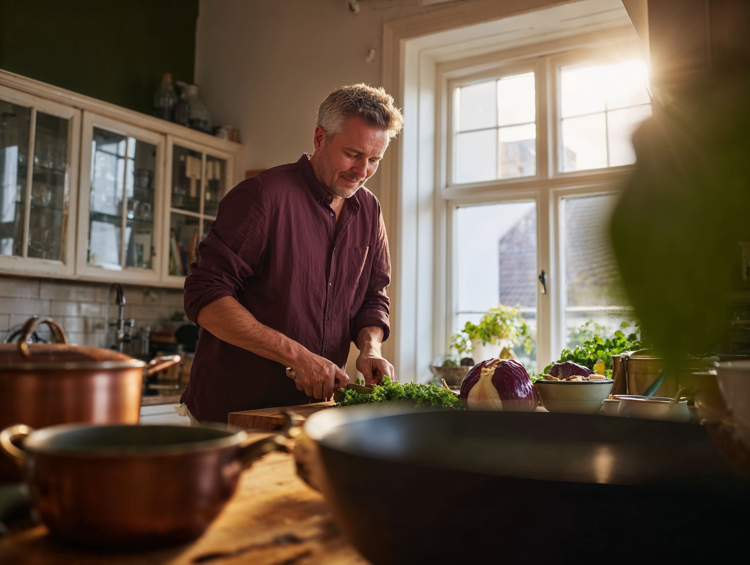 Man preparing fresh vegetables in a warmly lit home kitchen